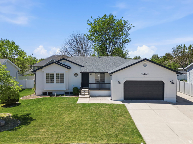 2460 Allison Way Syracuse, UT 84075 - Photo 1 of 24 White exterior with dark trim and a dark gray garage door