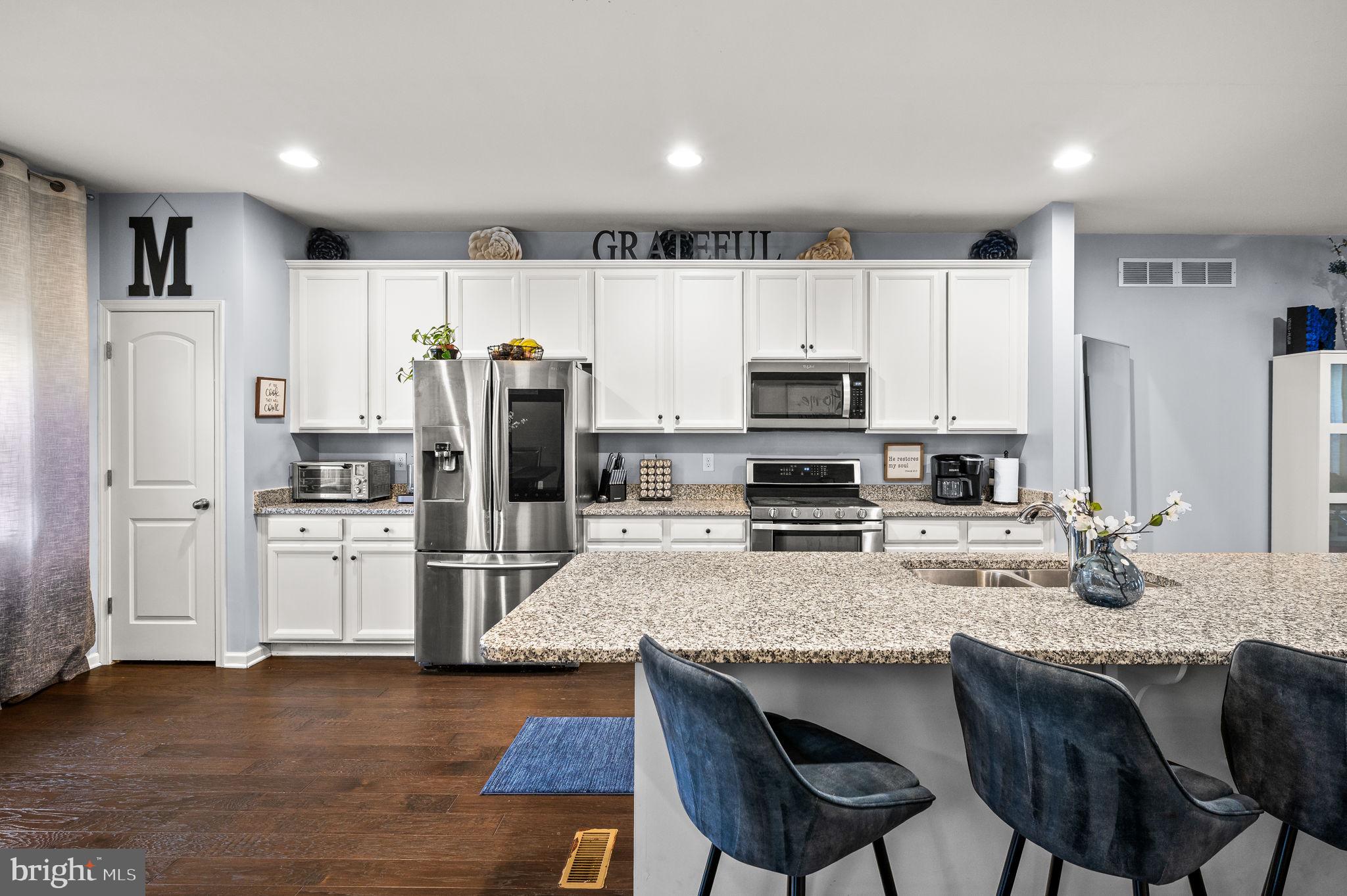 131 Time Circle Bear, DE 19701 - Photo 11 of 35 a kitchen with refrigerator cabinets and wooden floor