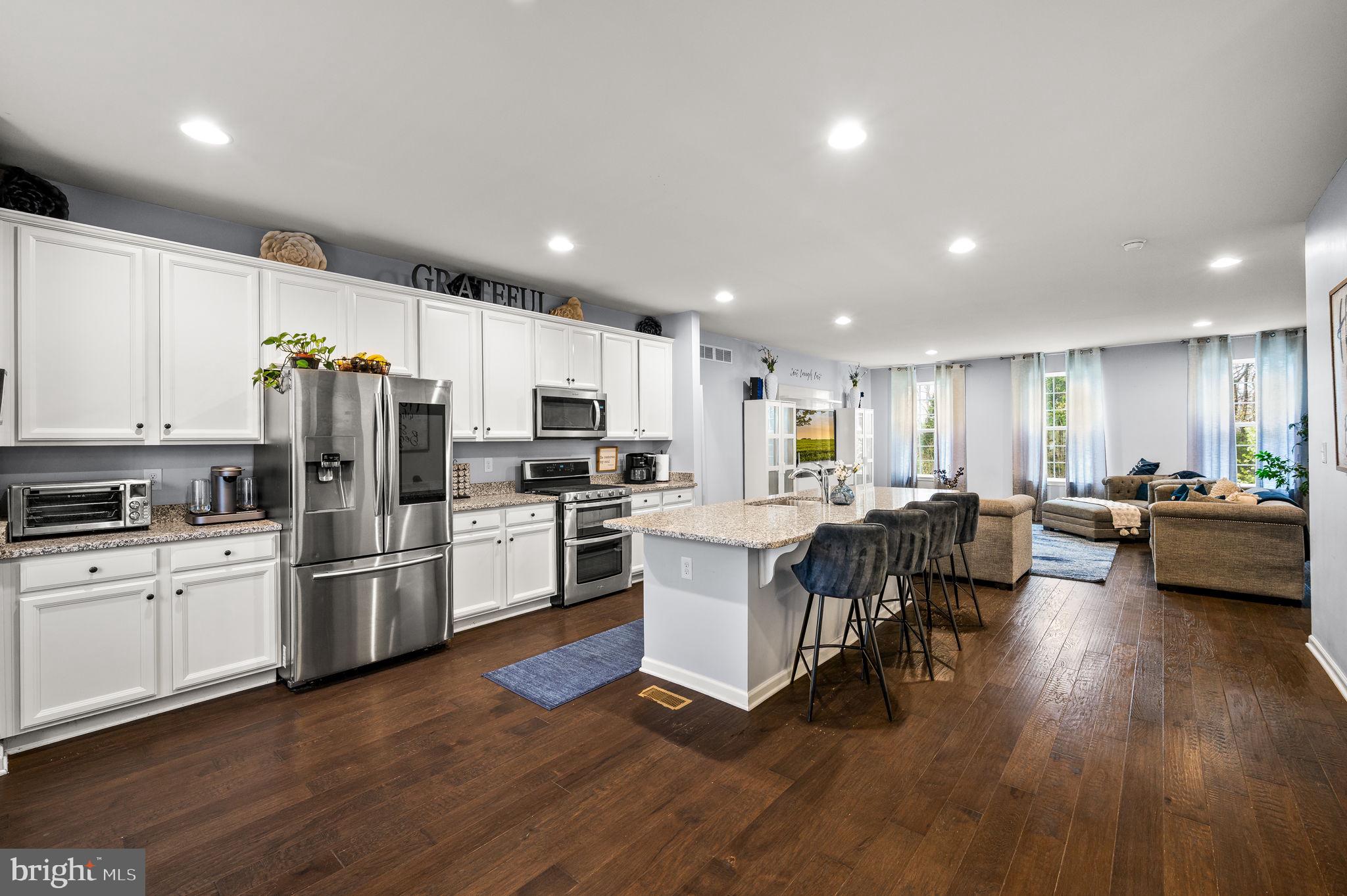 131 Time Circle Bear, DE 19701 - Photo 12 of 35 a kitchen with white cabinets and stainless steel appliances
