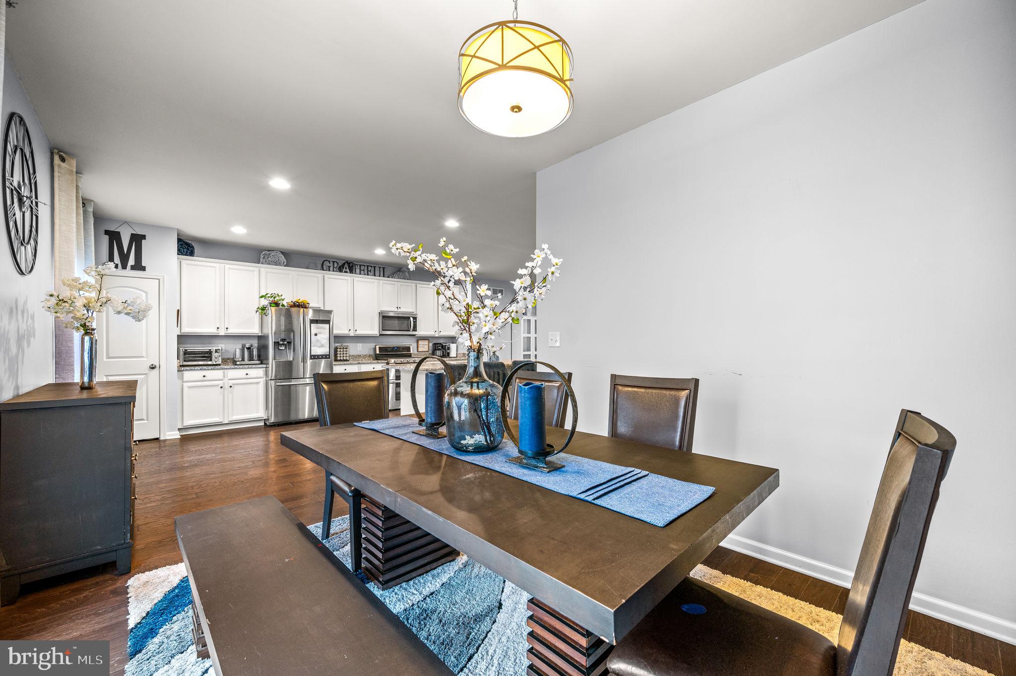 131 Time Circle Bear, DE 19701 - Photo 16 of 35 a living room with kitchen island furniture and a chandelier