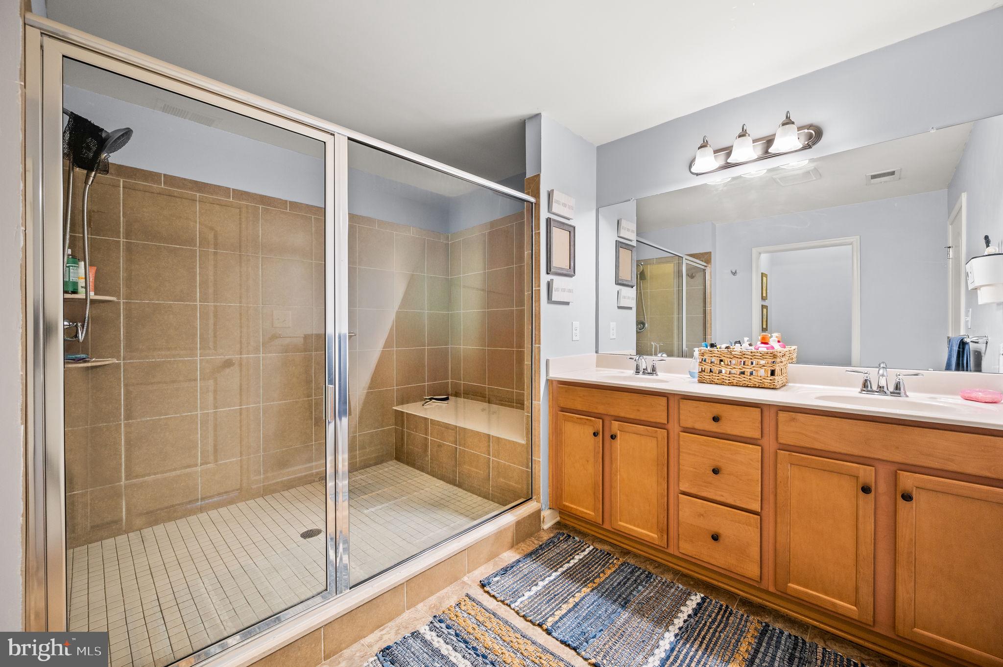 131 Time Circle Bear, DE 19701 - Photo 28 of 35 a bathroom with a double vanity sink a large mirror and shower