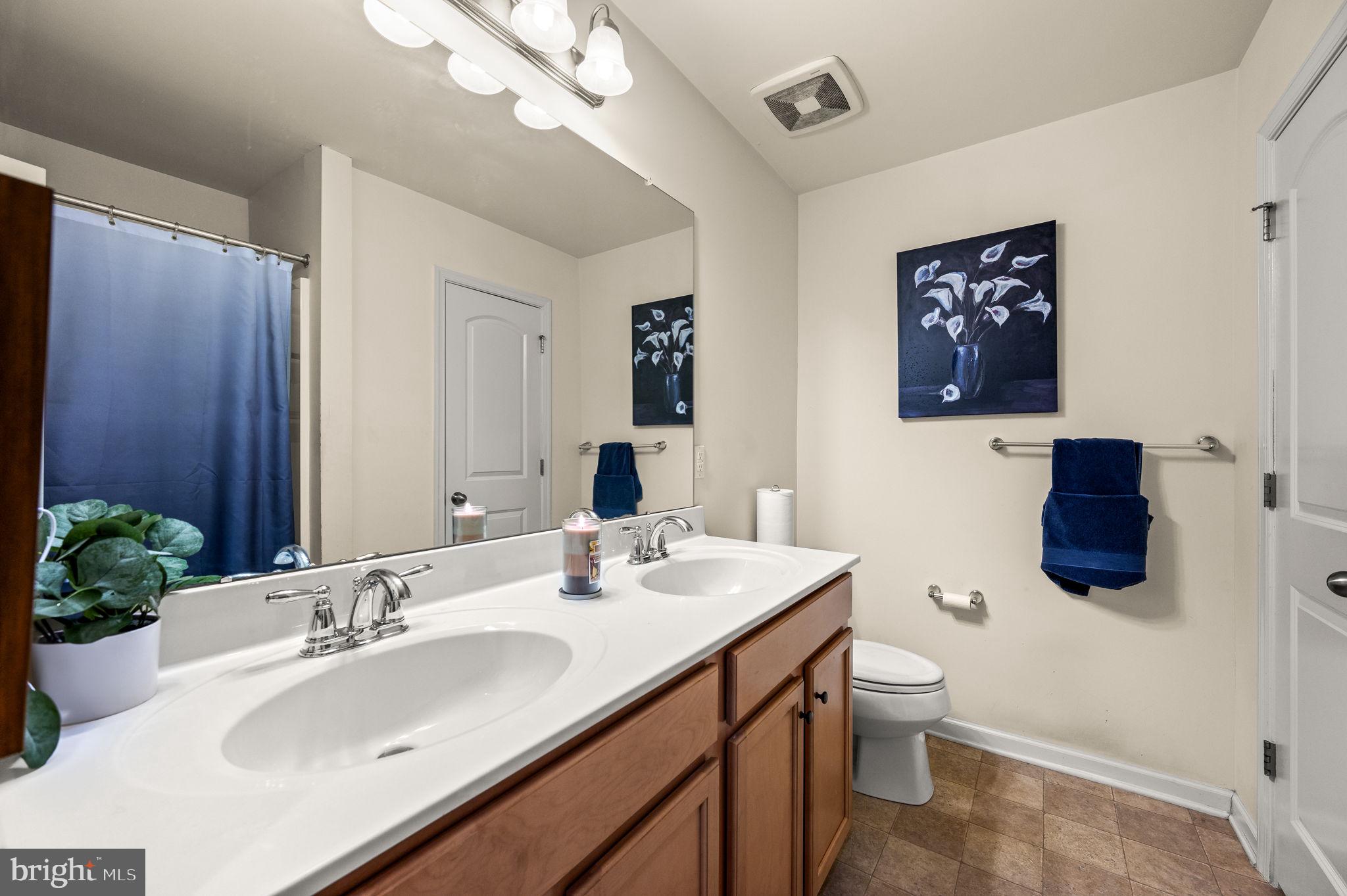 131 Time Circle Bear, DE 19701 - Photo 30 of 35 a bathroom with a toilet sink and mirror