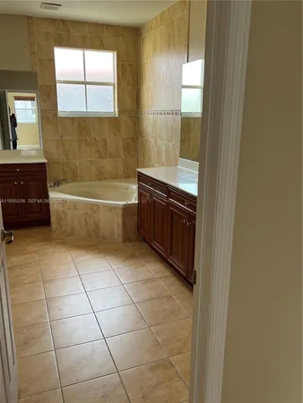 a white toilet sitting next to a shower