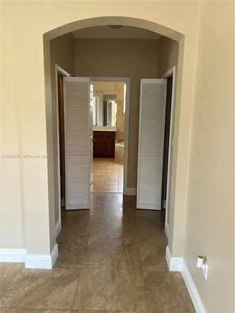 a view of kitchen with stainless steel appliances granite countertop a refrigerator and a stove top oven