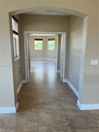 a kitchen with stainless steel appliances granite countertop a refrigerator a stove and a sink