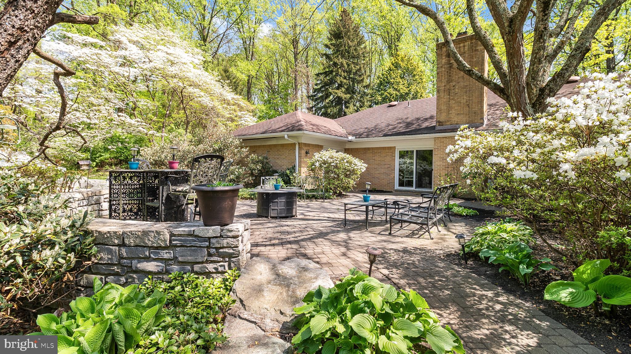 501 Webb Road Chadds Ford, PA 19317 - Photo 7 of 16 a view of a patio with table and chairs under an umbrella