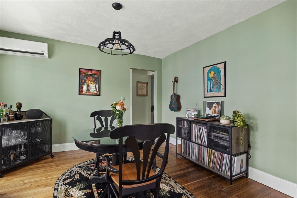 63-65 Brookley Road, Unit 3 Boston, MA 02130 - Photo 12 of 31 a view of a dining room with furniture wooden floor and a chandelier