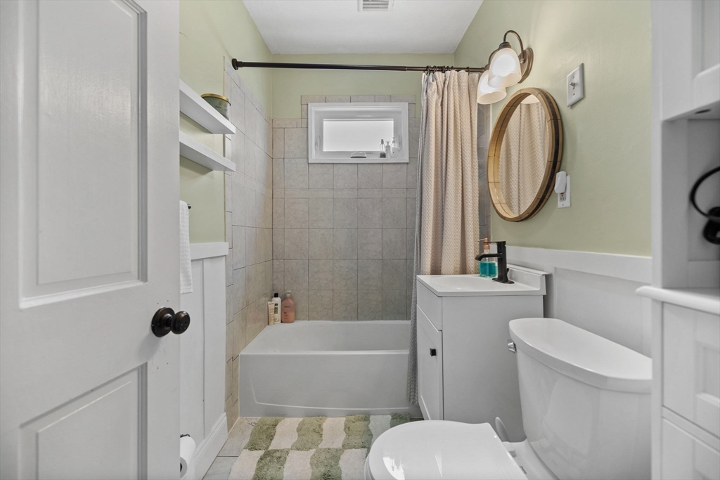 63-65 Brookley Road, Unit 3 Boston, MA 02130 - Photo 18 of 31 a bathroom with a toilet sink and mirror