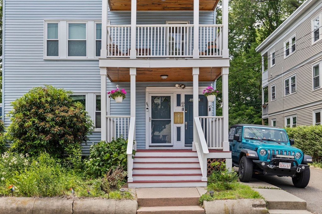 63-65 Brookley Road, Unit 3 Boston, MA 02130 - Photo 28 of 31 a front view of a house with a garden