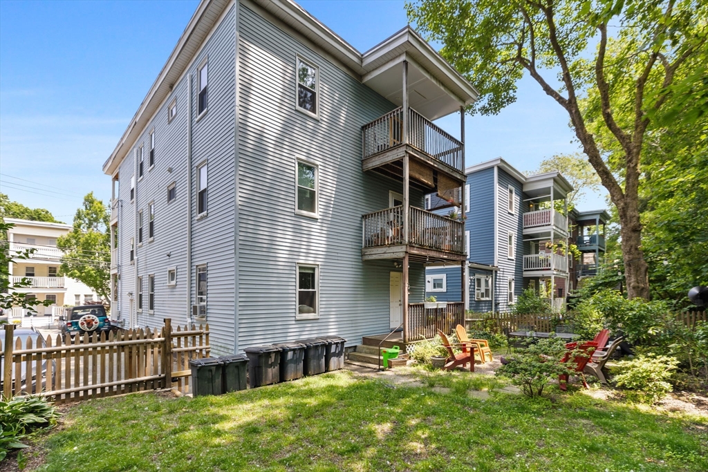 63-65 Brookley Road, Unit 3 Boston, MA 02130 - Photo 29 of 31 a front view of a house with a yard
