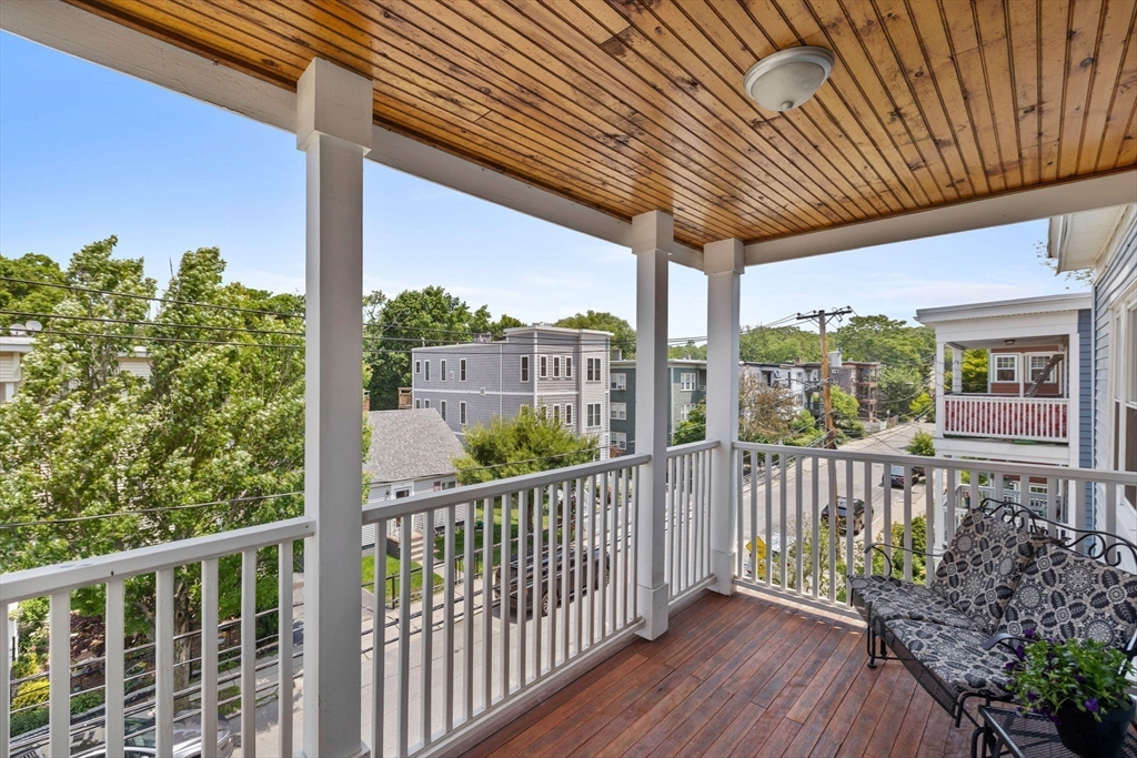 63-65 Brookley Road, Unit 3 Boston, MA 02130 - Photo 4 of 31 a view of a porch with wooden floor
