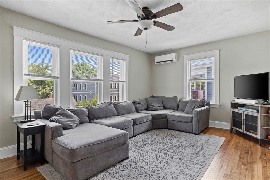 63-65 Brookley Road, Unit 3 Boston, MA 02130 - Photo 8 of 31 a living room with furniture a flat screen tv and windows