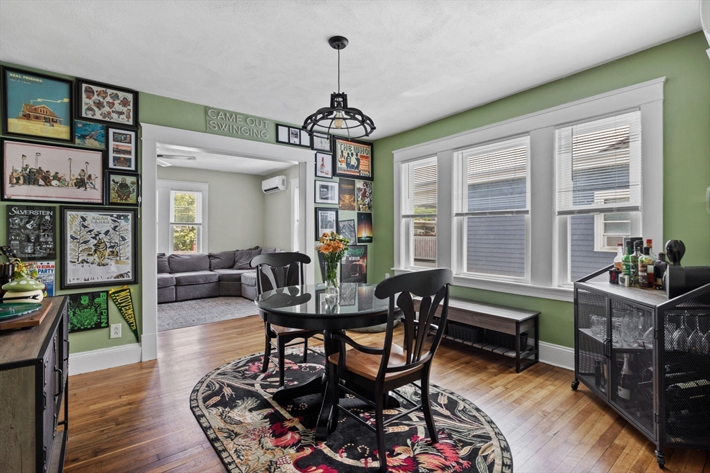 63-65 Brookley Road, Unit 3 Boston, MA 02130 - Photo 10 of 31 a dining room with furniture a chandelier and wooden floor