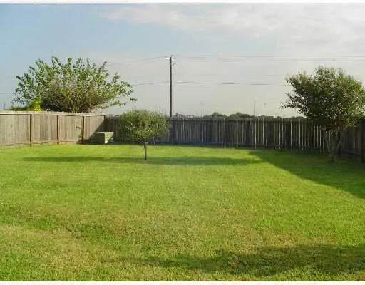 a view of a yard with a fence