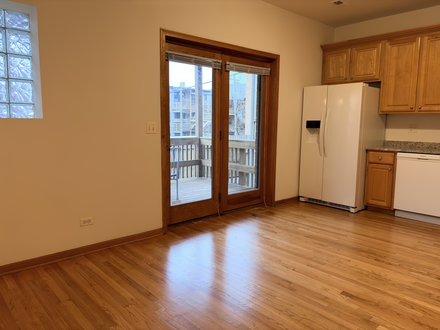 4101 North Kenmore Avenue, Unit 2S Chicago, IL 60613 - Photo 4 of 11 a view of a kitchen with wooden floor and a refrigerator