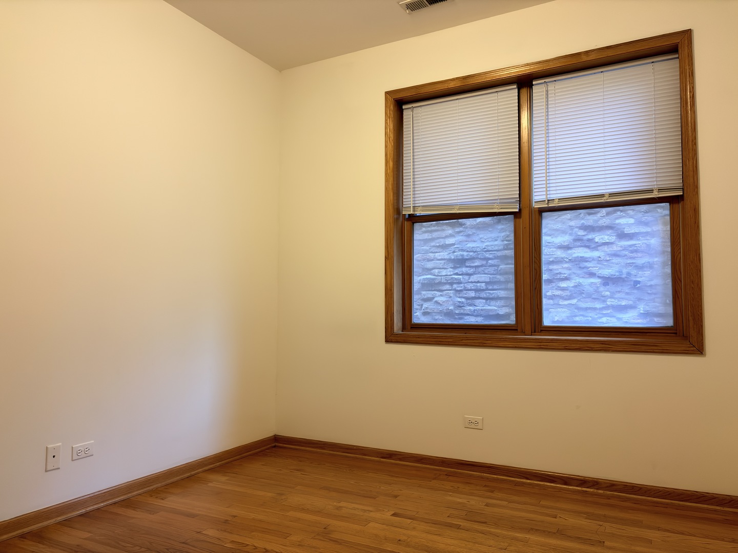 4101 North Kenmore Avenue, Unit 2S Chicago, IL 60613 - Photo 6 of 11 an empty room with wooden floor and a window