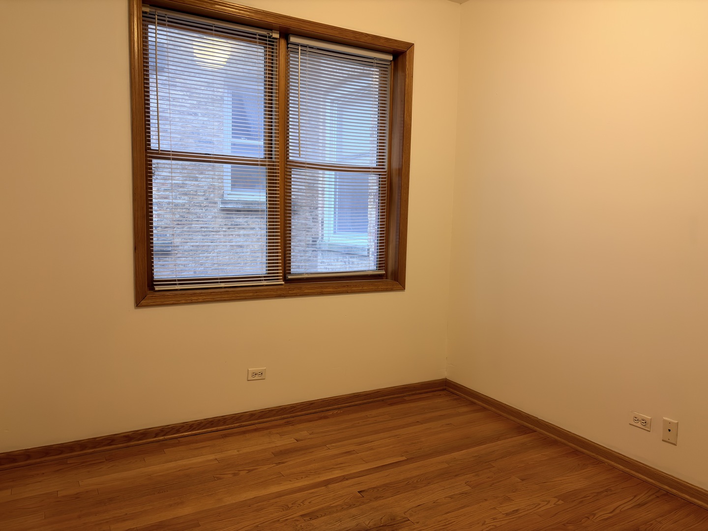 4101 North Kenmore Avenue, Unit 2S Chicago, IL 60613 - Photo 7 of 11 a view of an empty room with wooden floor and a window