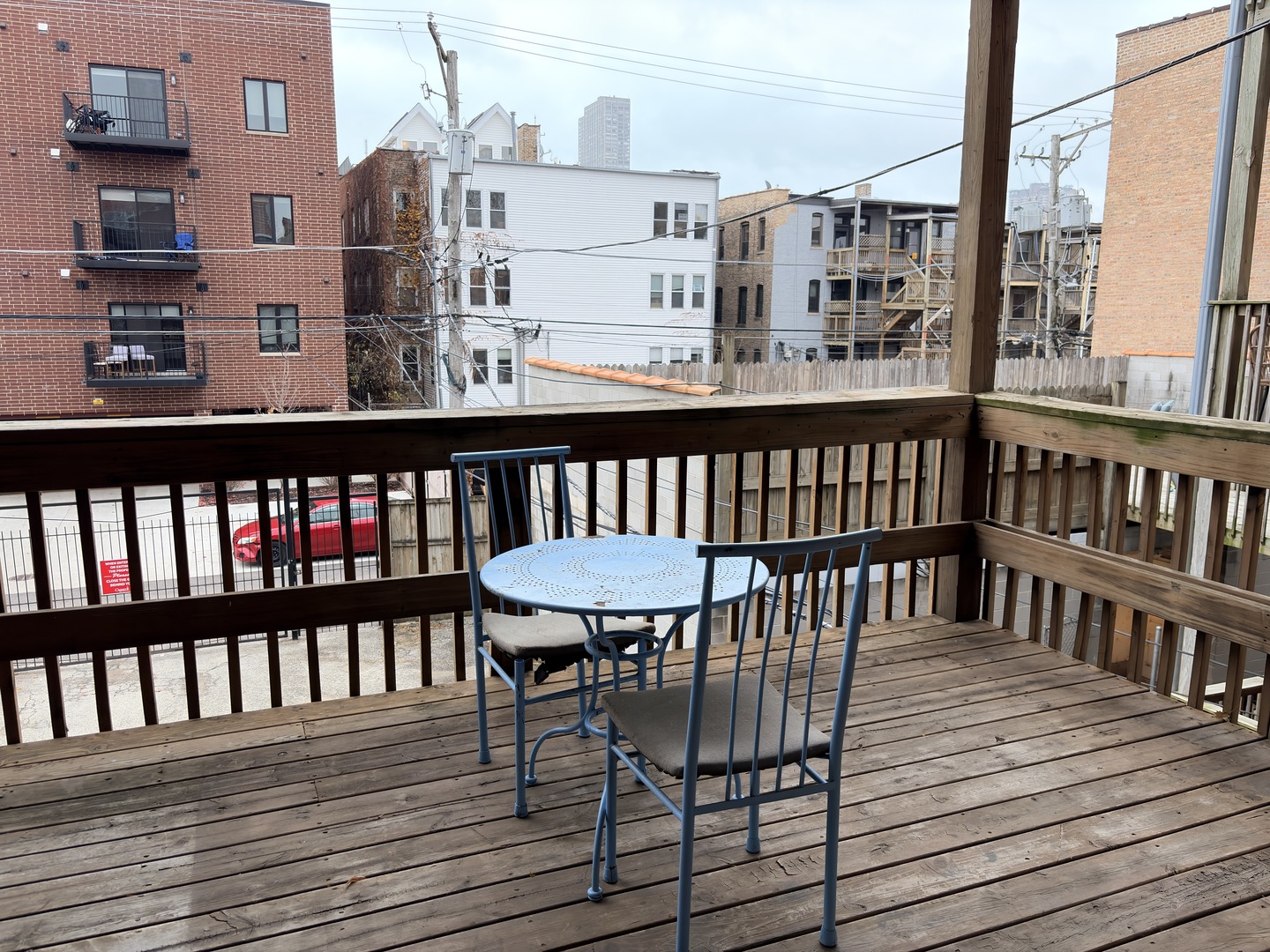 4101 North Kenmore Avenue, Unit 2S Chicago, IL 60613 - Photo 9 of 11 a view of a balcony with wooden chairs