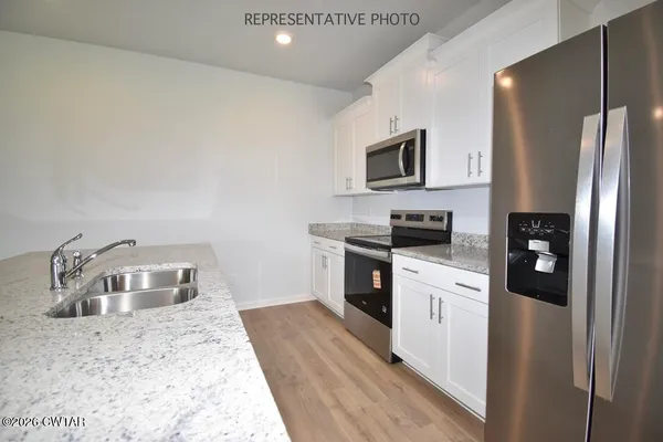 a kitchen with a refrigerator stove and microwave