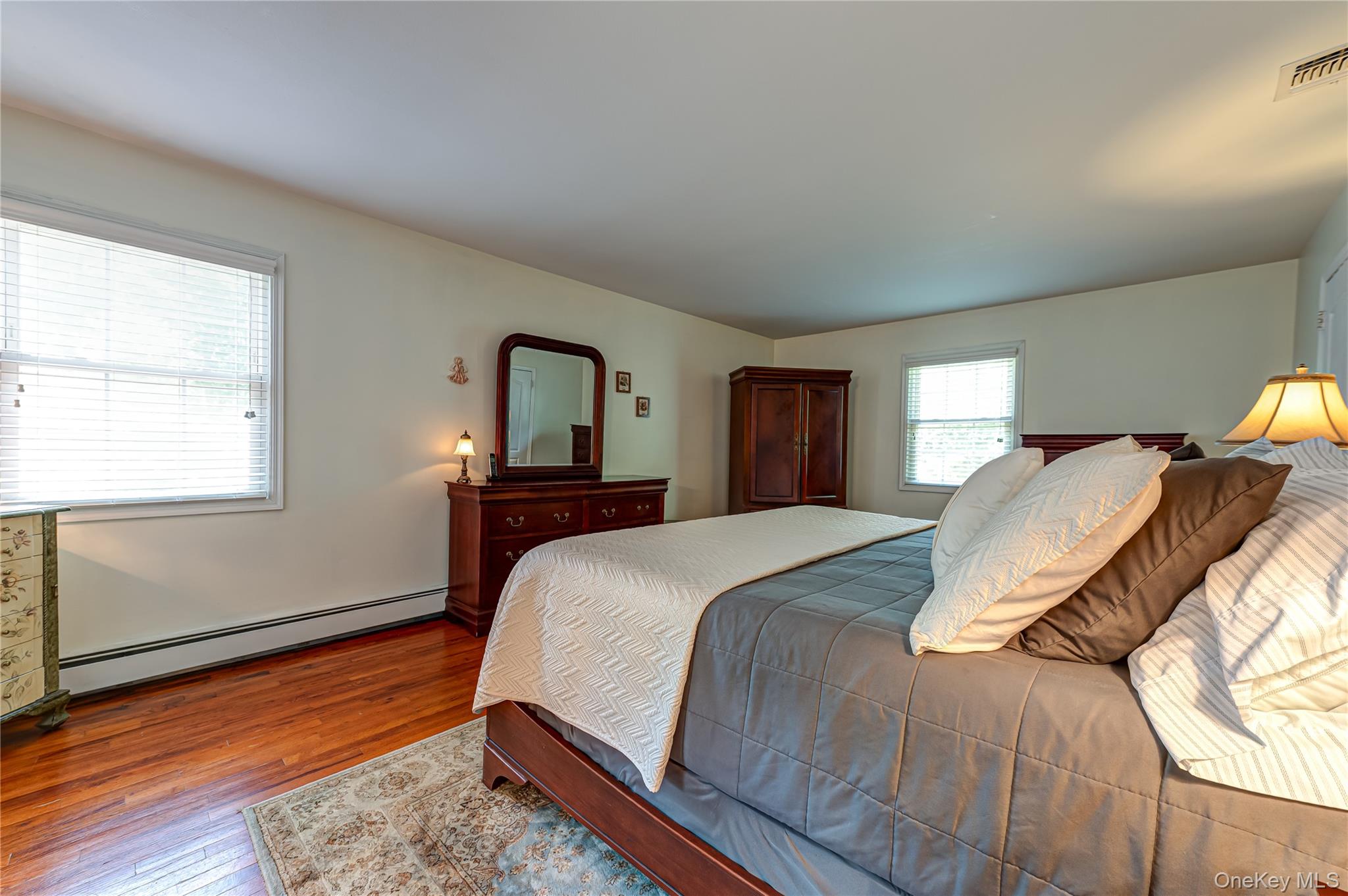 3 Thompson Hill Road St. James, NY 11780 - Photo 16 of 34 a bed sitting in a bedroom next to a window