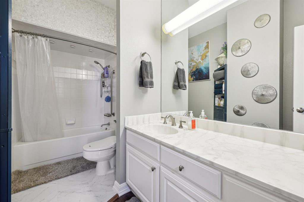 5200 Keller Springs Road, Unit 815 Dallas, TX 75248 - Photo 18 of 35 a bathroom with a granite countertop sink mirror vanity and toilet