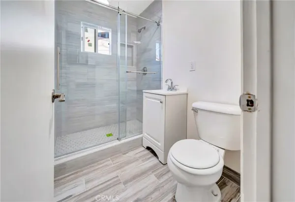 a white toilet sitting next to a bathroom sink