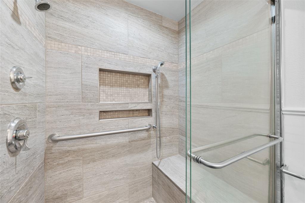 903 Lynn Street Bonham, TX 75418 - Photo 15 of 29 a bathroom with a glass shower door