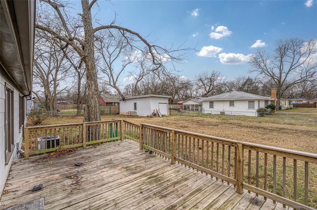 903 Lynn Street Bonham, TX 75418 - Photo 22 of 29 a view of a balcony with wooden fence