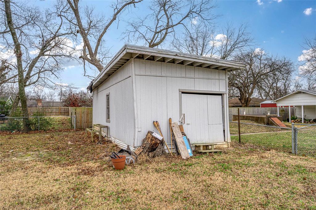 903 Lynn Street Bonham, TX 75418 - Photo 24 of 29 a view of a house with a yard and large tree