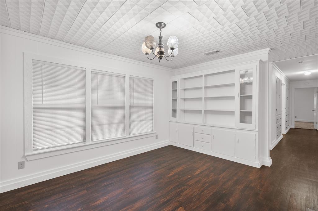 903 Lynn Street Bonham, TX 75418 - Photo 5 of 29 wooden floor in an empty room with a window