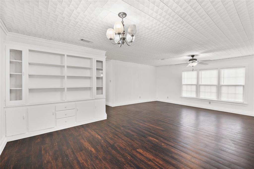903 Lynn Street Bonham, TX 75418 - Photo 6 of 29 wooden floor in an empty room with a window