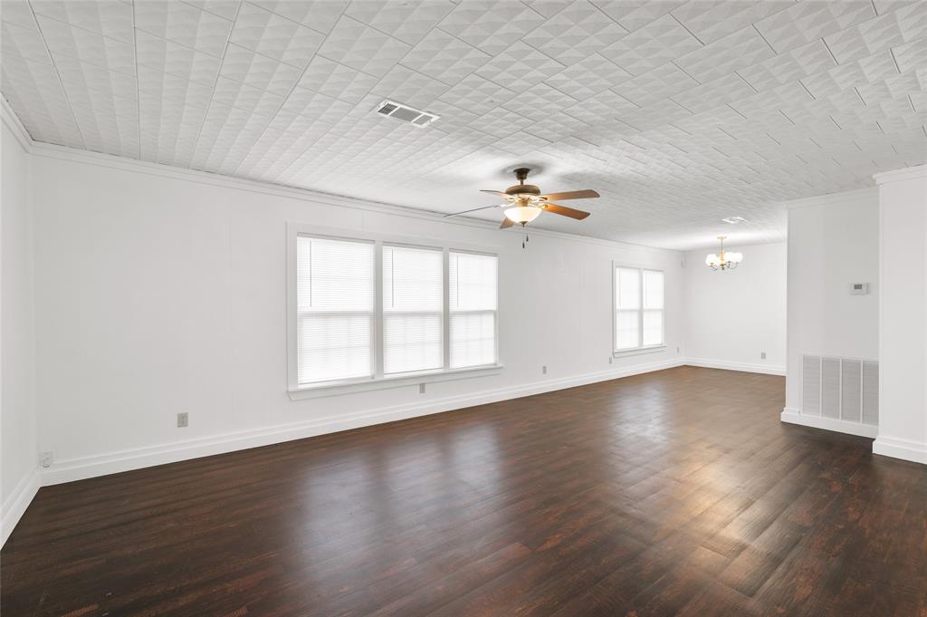 903 Lynn Street Bonham, TX 75418 - Photo 7 of 29 an empty room with wooden floor and windows