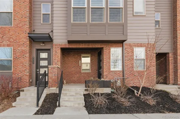 a front view of a house with outdoor seating