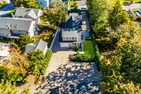 view of a house with a yard and garden