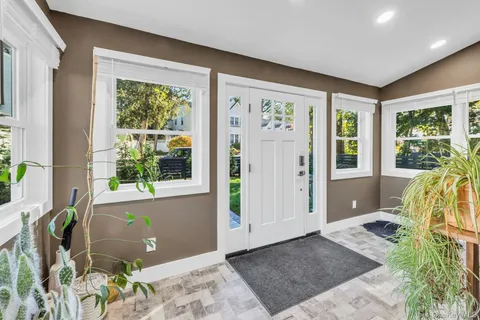 a view of an entryway with wooden floor and a rug