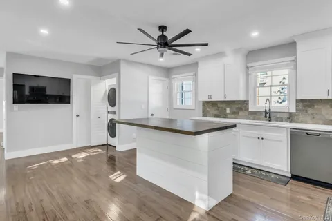 a kitchen with a sink cabinets and window