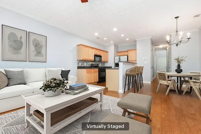 a living room with furniture and kitchen view