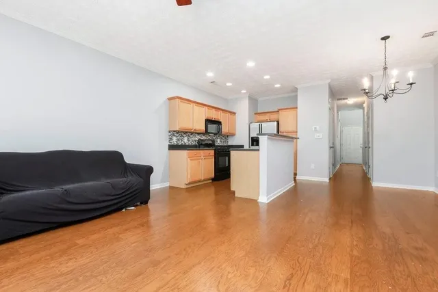 a living room with furniture and kitchen view