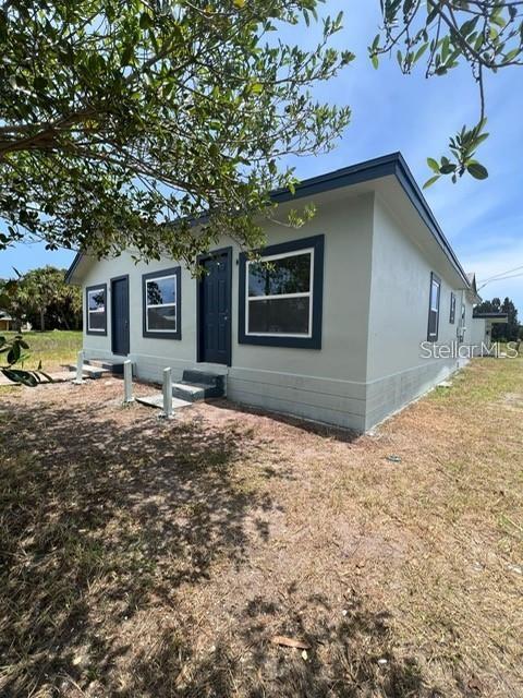 2513 Lipscomb Street Melbourne, FL 32901 - Photo 2 of 4 a house with trees in the background
