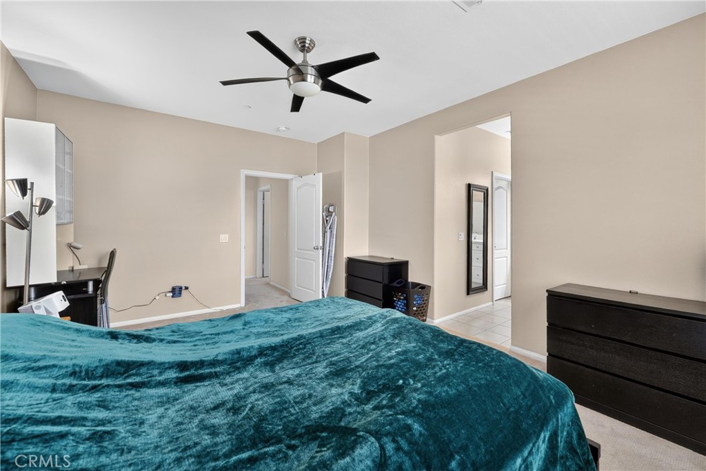 849 The Promenade, Unit D Azusa, CA 91702 - Photo 25 of 37 a bedroom with a bed and a chandelier