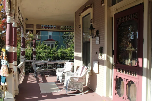 a view of a white house with large windows