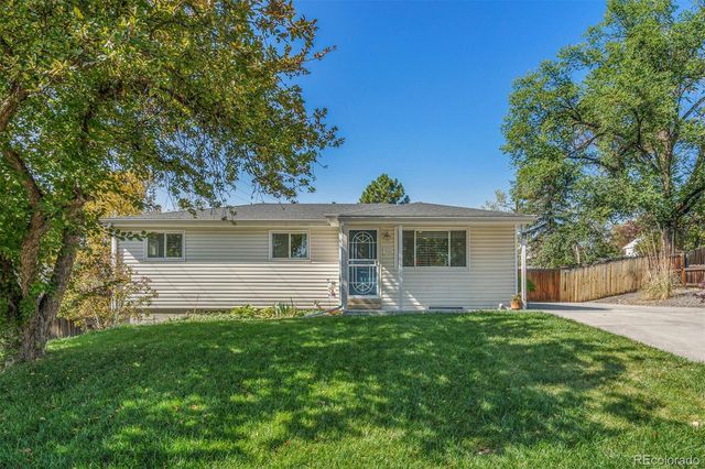 a front view of house with a garden
