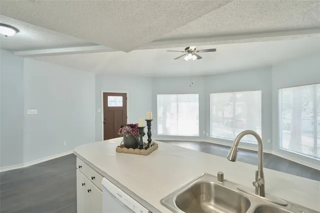 a kitchen with a sink appliances and a window