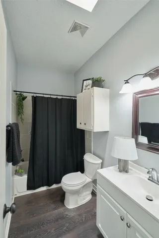 a bathroom with a sink toilet a mirror and vanity