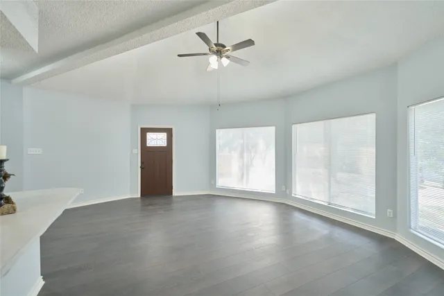 wooden floor in an empty room with a window