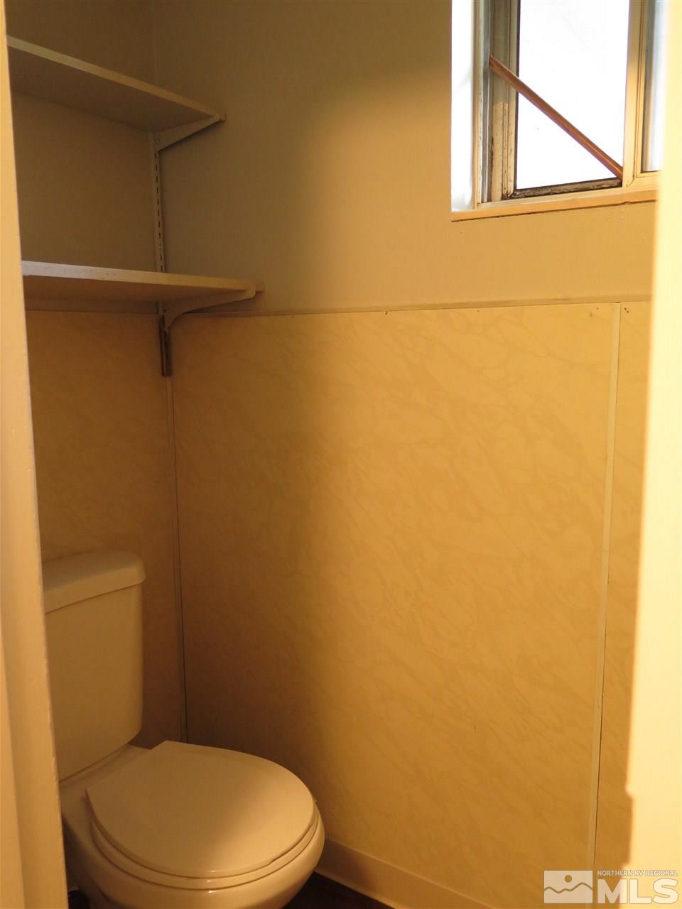 1825 Hawthorne Road Reno, NV 89502 - Photo 16 of 21 a white toilet sitting next to a shower