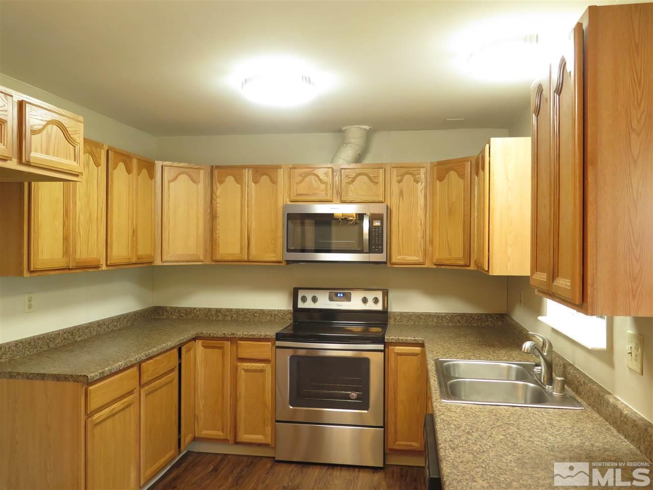 1825 Hawthorne Road Reno, NV 89502 - Photo 7 of 21 a kitchen with a stove a sink and a microwave