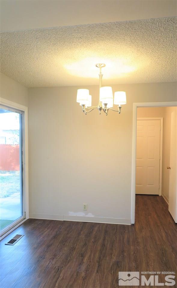 1825 Hawthorne Road Reno, NV 89502 - Photo 8 of 21 an empty room with wooden floor and windows