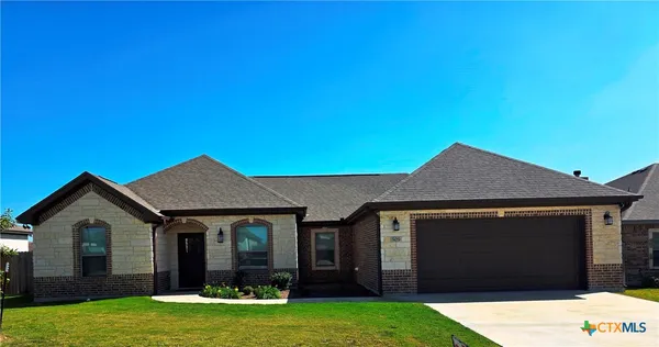 a front view of a house with yard