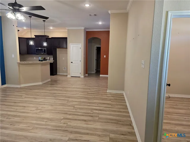 a view of a kitchen with a sink and cabinets